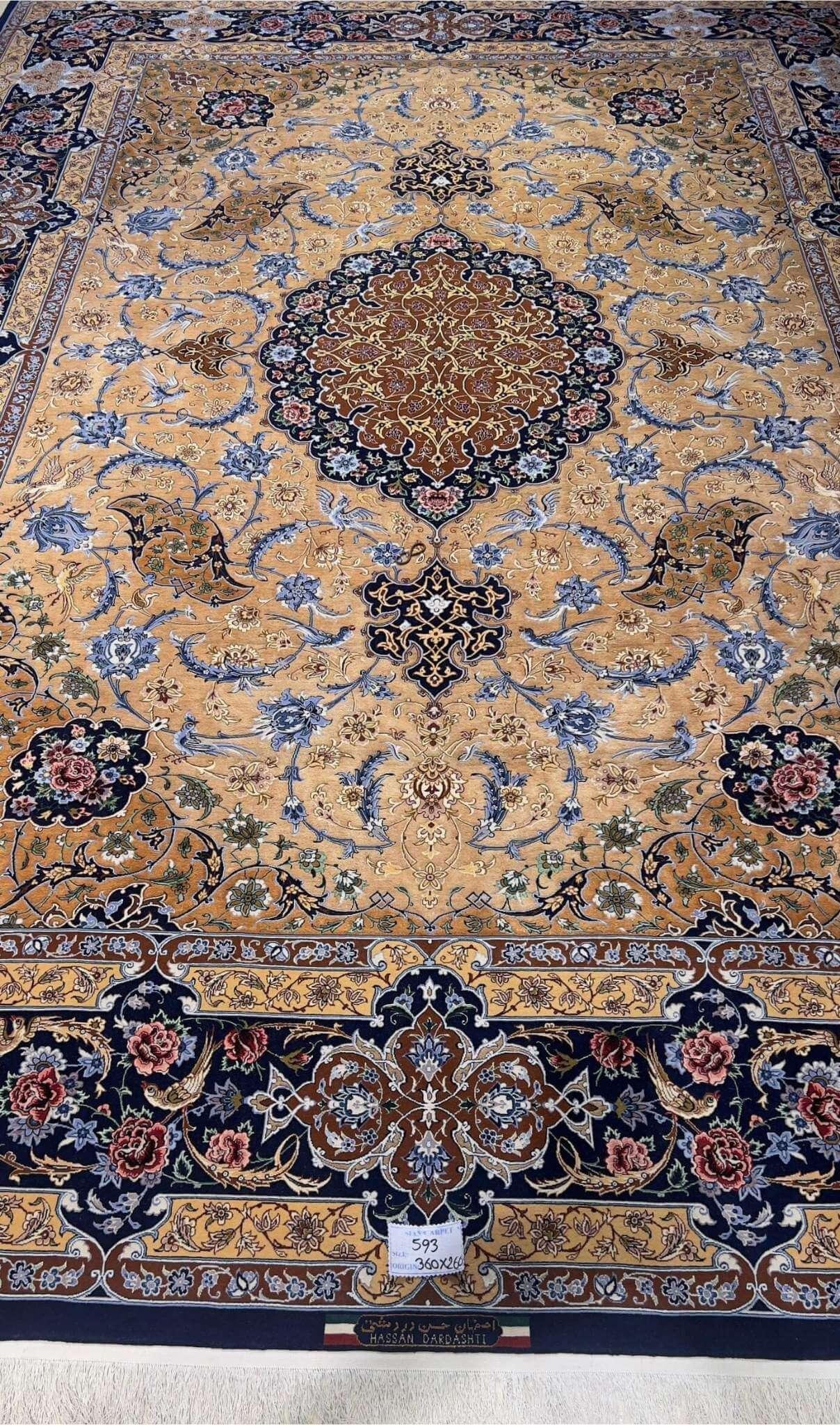 "Hand-knotted Isfahan rug with a golden base and intricate floral patterns, crafted by Master Hassan Dardashtie."